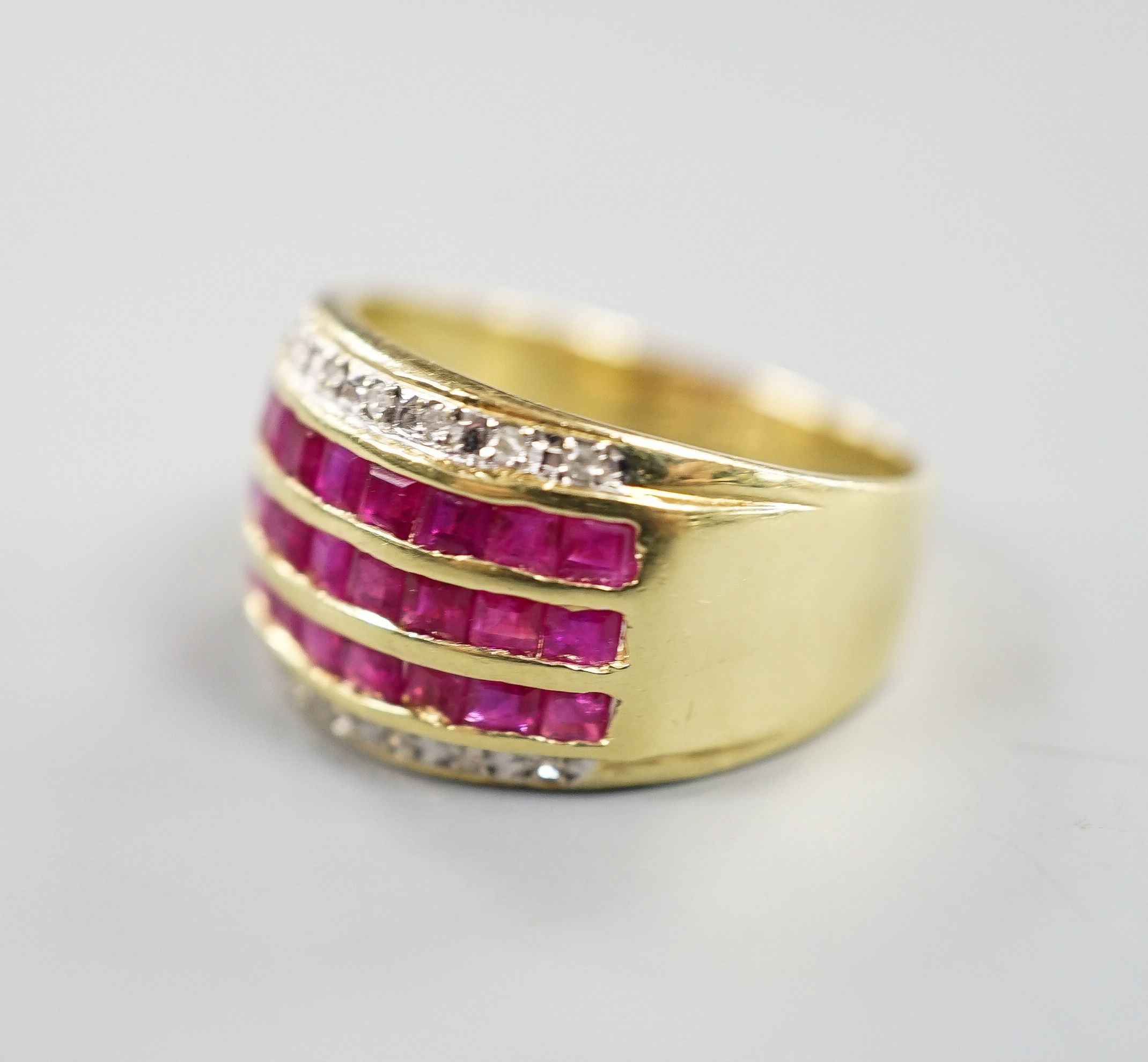 A modern 14k yellow metal, five row ruby and diamond set dress ring. size O, gross weight 4.9 grams.